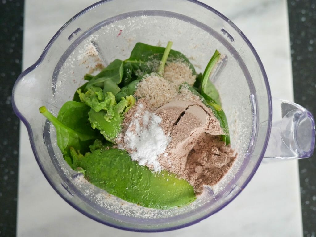 Main ingredients with supplements on top in a blender