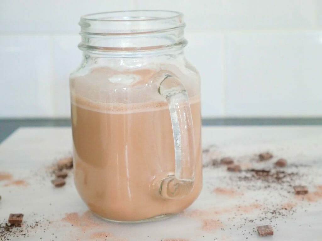 A high protein coffee made from protein powder in coffee on a marble surface