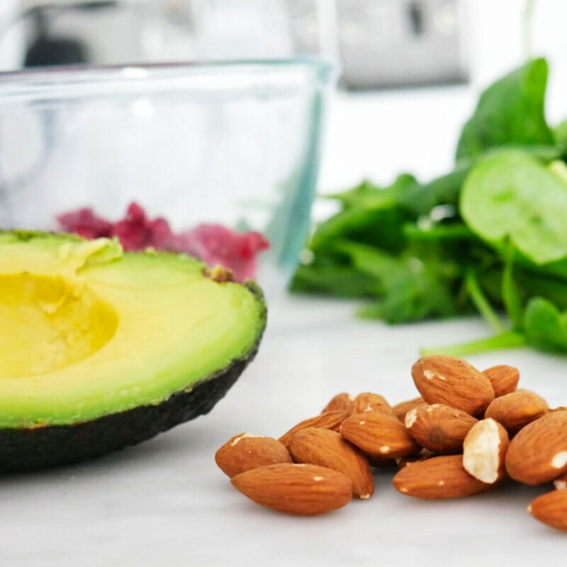 Ingredients for a Keto smoothie - avocado, almonds, raspberries and spinach