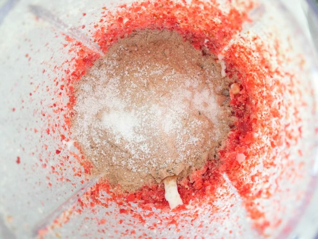 Strawberry chocolate protein shake ingredients in a blender
