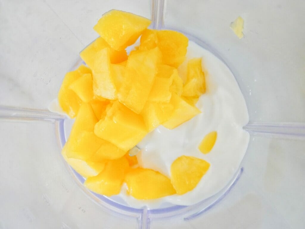 Mango and coconut yogurt in a blender