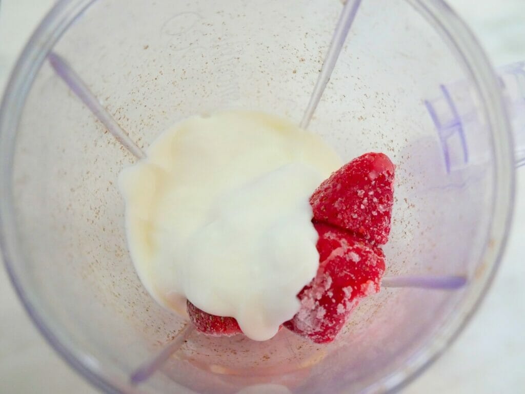strawberry banana smoothie with yogurt in a blender