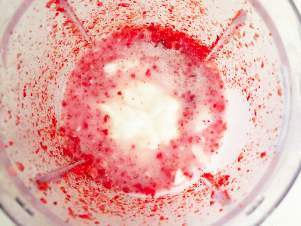 Strawberry coconut smoothie ingredients in blender
