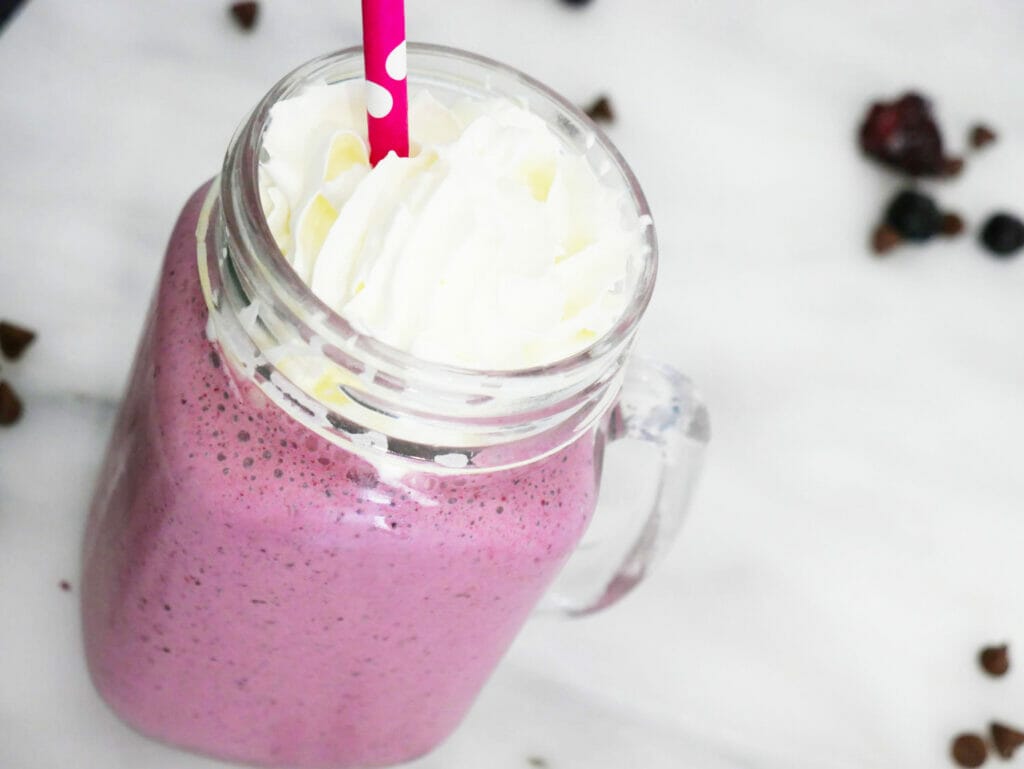 Healthy blueberry smoothie with cream on top